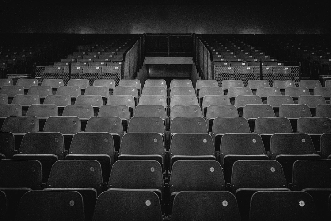 Empty modern conference hall set up with chairs facing a presentation screen